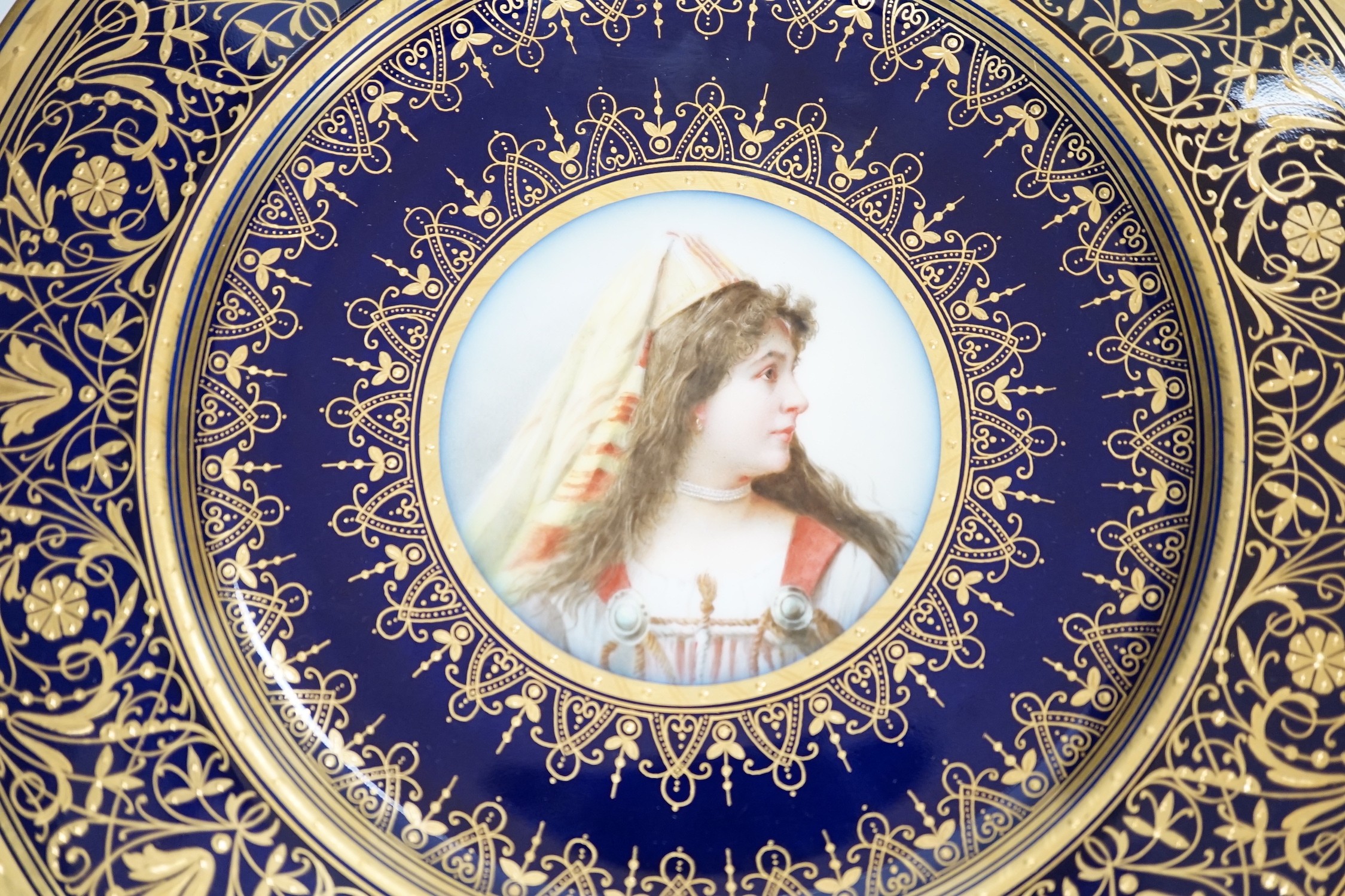 A pair of Pirkenhammer gilt and portrait painted cabinet plates, 25cm diameter